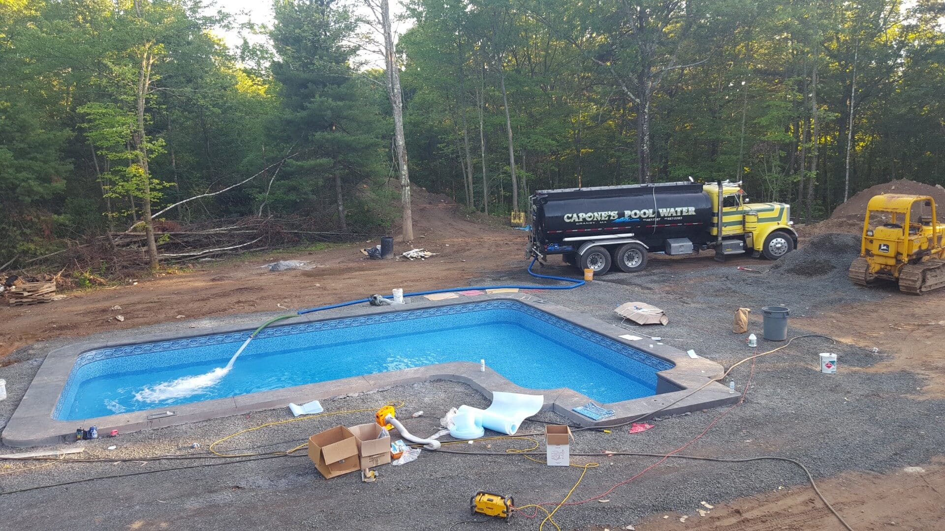 A truck is parked next to the pool.