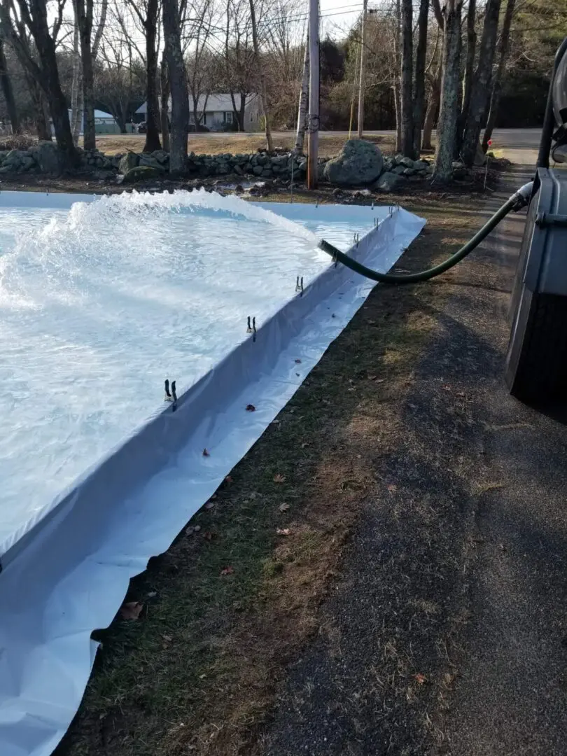 A pool that has been opened up and is being cleaned.