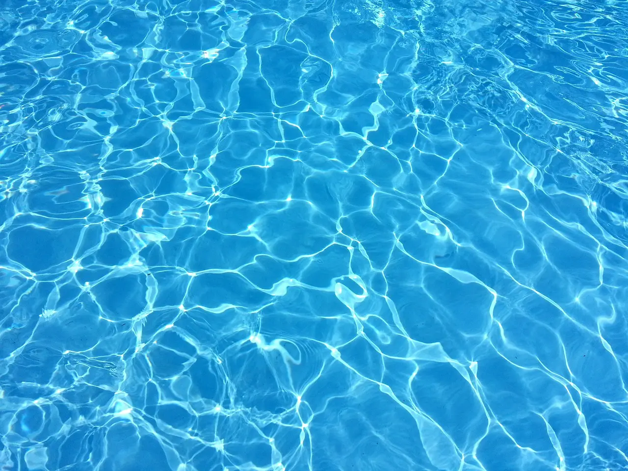 A pool with blue water and ripples on it.