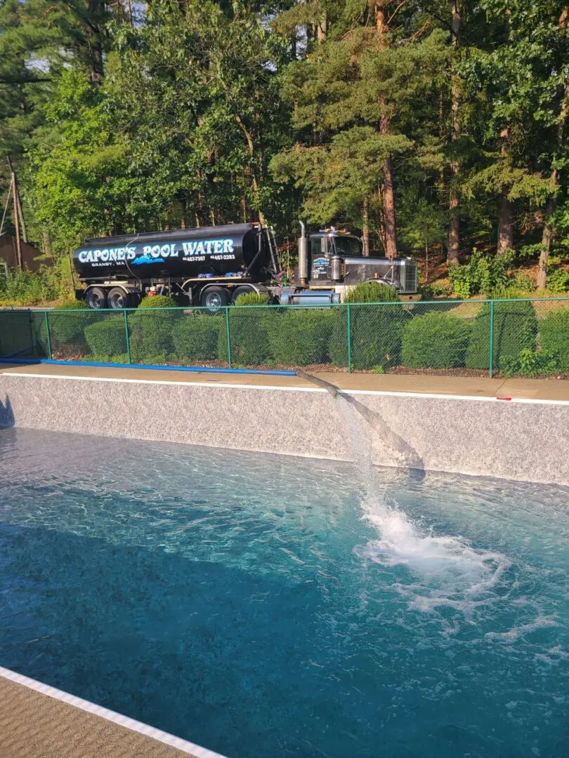 A truck is in the background of a pool.